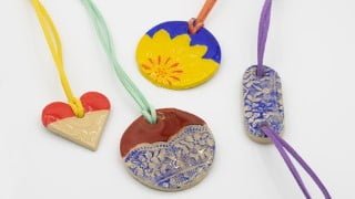 Clay jewelry with a coating of resin