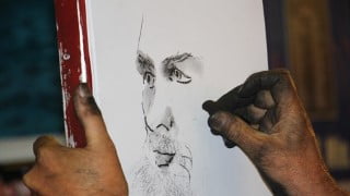 Drawing a portrait in charcoal